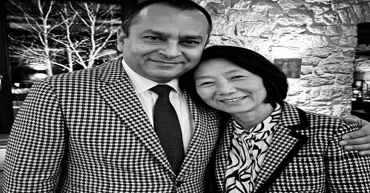 Keiko Fujimoto and Sunny Balwani posing together in matching houndstooth blazers, smiling in a black and white photo.
