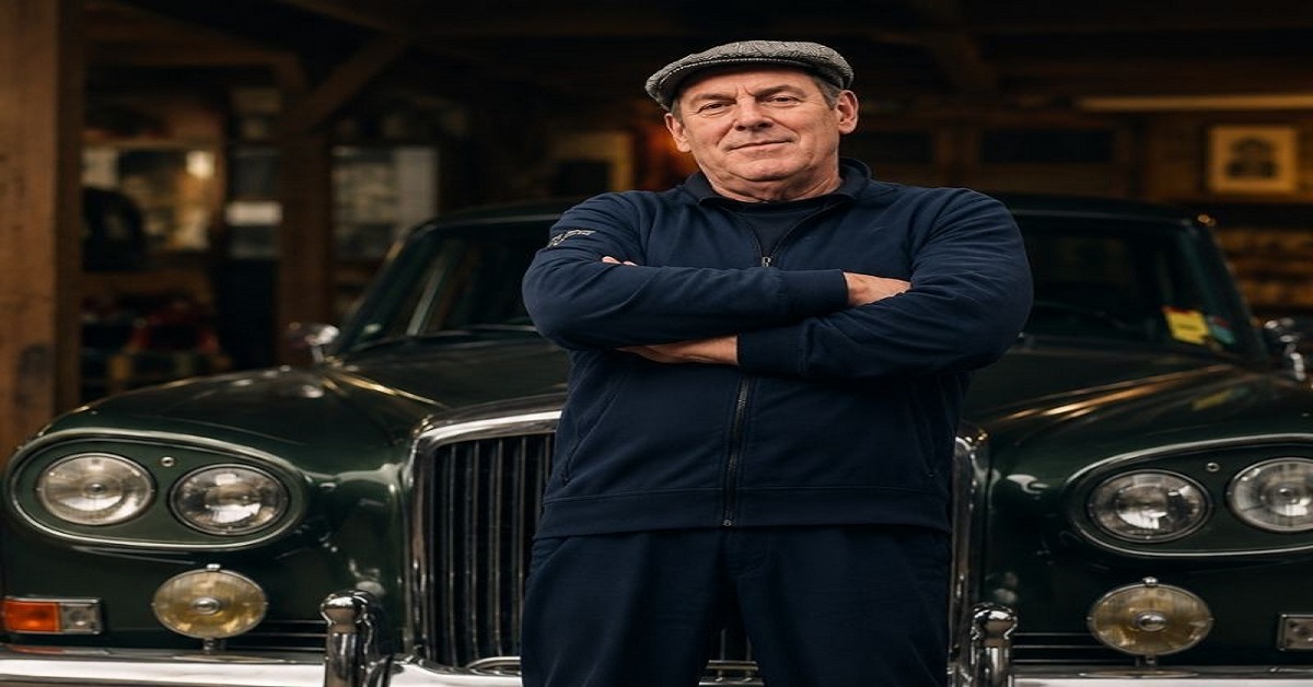 Derek Mathewson standing in front of a classic green car at Mathewsons auction house in North Yorkshire