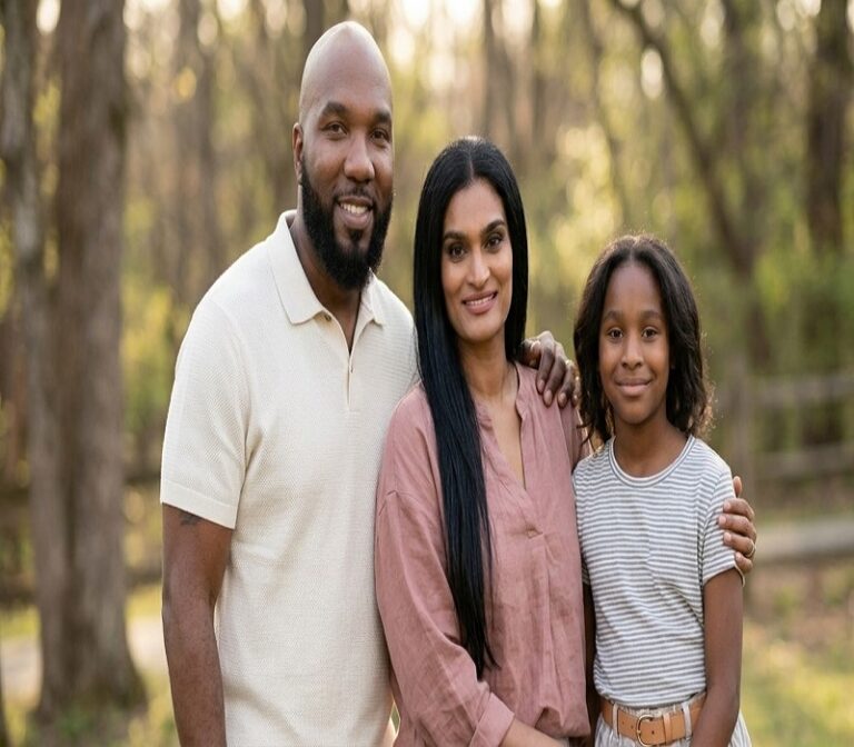 Amra Nor Jenkins with her father Young Jeezy and mother Mahlet Mahi Gebremedhin posing together for a family photo outdoors surrounded by trees.